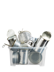 Different types and sizes of used metal cans and tins for recycling in container on white isolated background