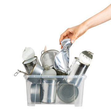 Female hand putting used can for recycling into container with metal on white isolated background