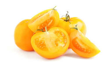 Cut and whole yellow tomatoes on white background