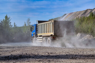A dump truck carries cargo from a quarry. Quarry mining.
