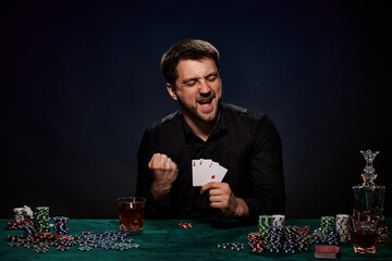 Bearded casino player man playing poker on green table