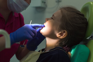 child is being examined by an orthodontist