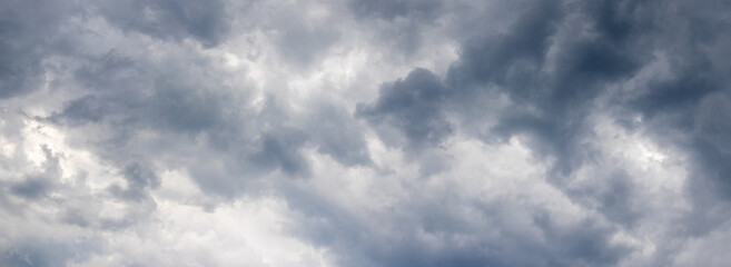 Naklejka na ściany i meble Dark stormy sky with bizarre torn clouds before the rain, panorama