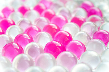 Gentle pink white beautiful abstract background of gel balls. Macro of hydrogel round form. Pattern of polymer. Female girly or wedding wallpaper