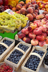 Various fruits and colors on the fruit market stand, end of summer