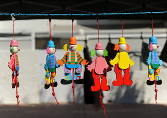 Articulated wooden toys for children. Wooden dolls of colored clowns for sale at a craft market....