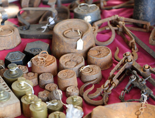 Antique bronze and rusty weights for sale at a second-hand and used flea market. Set of old weight measurements