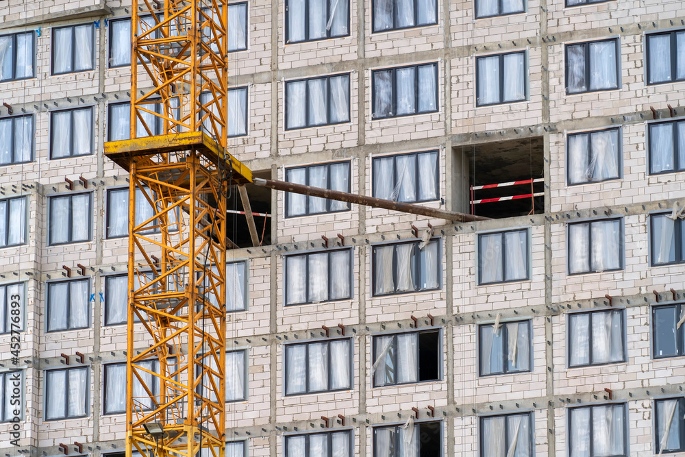 Poster view of frame part of metallic crane machinery attachment at flats of new residential building const
