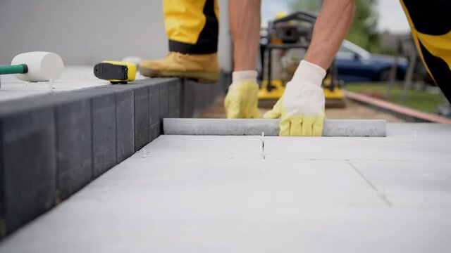 Outdoor Patio Tiles Installation by Professional Worker
