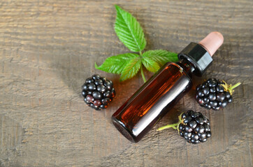 Blackberry seed essential oil in a glass bottle for skin care, naturopathy and wellness.Rubus...