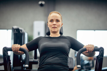 A woman is engaged in fitness in the gym to lose weight and burn extra calories, a healthy...