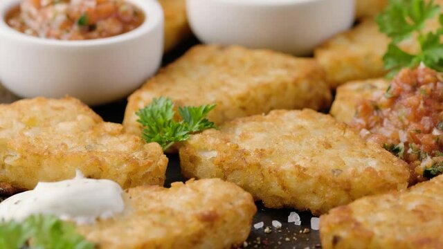 Hash brown potato patties on rustic oven tray
