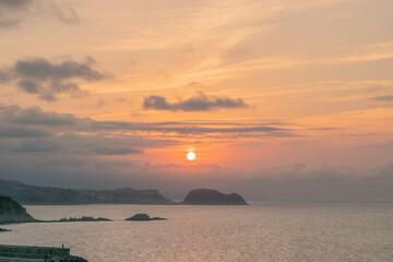 Sunset at sea with mountains