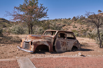 Old rusty car wreck abandoned in the desert, Namibia.