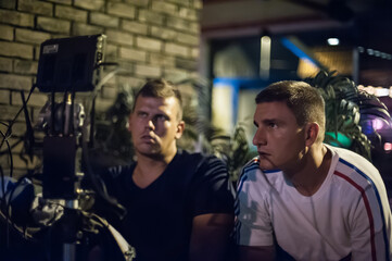 Behind scenes. Film director oversees and control shooting of film