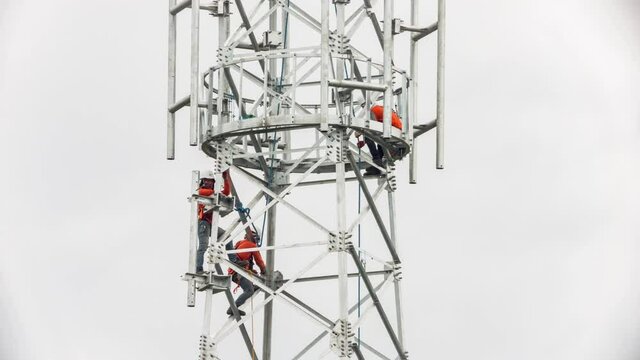 Technician Installing Telecommunication Tower of 4G and 5G cellular.