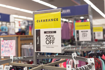 25 percent off clearance sign on a round clothing rack at fashion store in America - obrazy, fototapety, plakaty