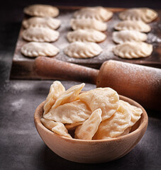 dumplings with potatoes and cherries on a wooden base with a fork