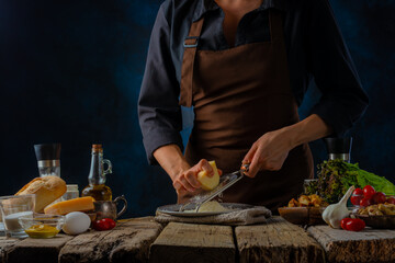 The chef prepares Caesar salad. All the ingredients you need are on the table. Delicious festive dish. New Year, Christmas, family holidays. Cookbook, step by step recipe, advertisement.