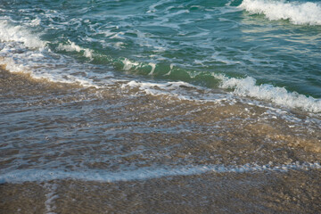 Sea or ocean tropical landscape view. Sea waves under the sun. Summer vacation and travel concept. Water wave surface. Sand beach. 