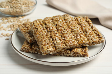 Delicious sweet kozinaki bars on white wooden table, closeup
