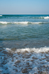 Sea or ocean tropical landscape view. Sea waves under the sun. Summer vacation and travel concept. Water wave surface. Sand beach. 
