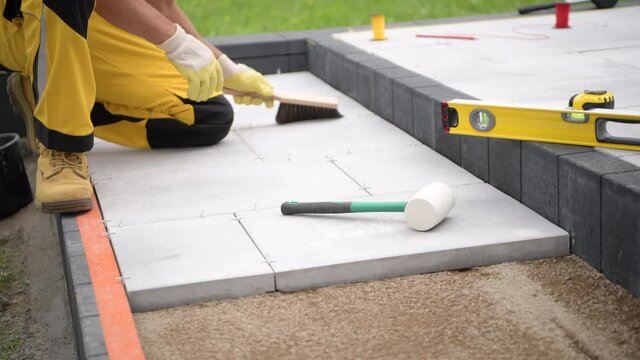 Concrete Brick Paving by Construction Industry Worker. 