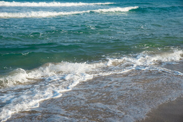 Sea or ocean tropical landscape view. Sea waves under the sun. Summer vacation and travel concept. Water wave surface. Sand beach. 