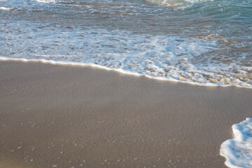 Sea or ocean tropical landscape view. Sea waves under the sun. Summer vacation and travel concept. Water wave surface. Sand beach. 