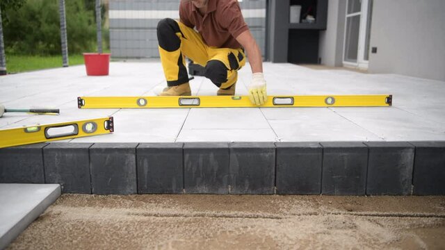 Concrete Brick Patio Floor Paving by Construction Industry Worker. 