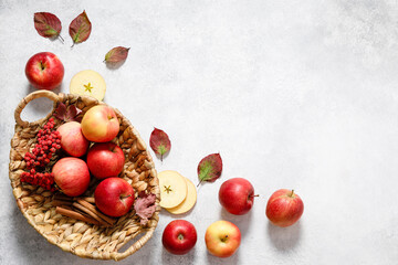 Naklejka na ściany i meble Red ripe apples in a wooden basket on white table background. Autumn apple flat lay, top view, copy space. Autumn harvest, apple cooking concept