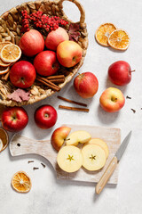 Fototapeta na wymiar Fresh ripe red apples with knife and chopping board on white table background. Autumn apple flat lay, top view, copy space. Autumn harvest and cooking apple meal, apple pie concept.