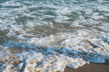 Sea or ocean tropical landscape view. Sea waves under the sun. Summer vacation and travel concept. Water wave surface. Sand beach. 