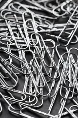 Silver Paper clips scattered as textured background