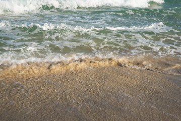 Sea or ocean tropical landscape view. Sea waves under the sun. Summer vacation and travel concept. Water wave surface. Sand beach. 