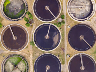 Round wastewater cleaning reservoirs at a sewage treatment facility. Grey water recycling, aerial view