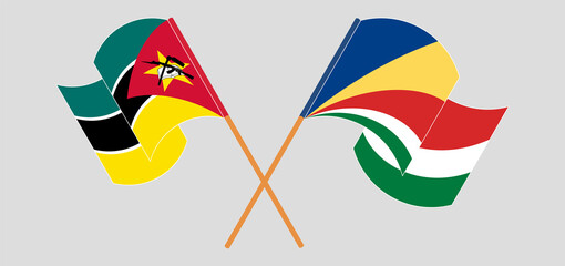 Crossed and waving flags of Mozambique and Seychelles
