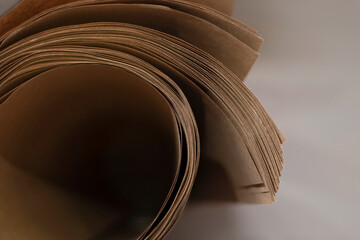 Kraft paper rolled into a roll, paper for printing vintage postcards, napkins, menus, cards. Printing materials at the printing company. Selective focus