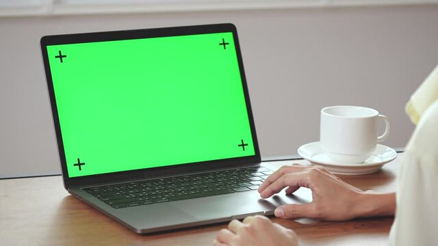 Woman scrolling computer screen. The screen is green for ready to use.