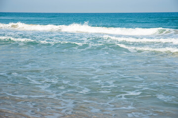 Sea or ocean tropical landscape view. Sea waves under the sun. Summer vacation and travel concept. Water wave surface. Sand beach. 