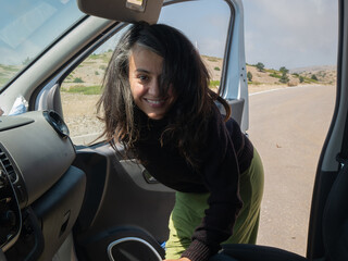 smiling girl getting into a van