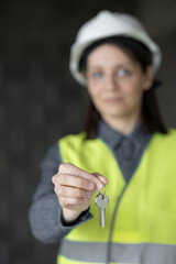woman engineer in a white helmet and safety vest, the engineer on the construction site makes measurements and discusses the work plan, a competent engineer and designer on the premises of the