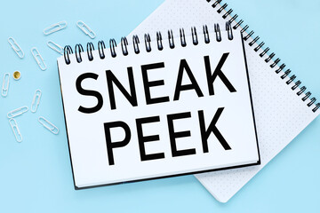 Sneak Peek. text on white notepad paper on blue background