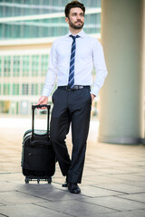 Businessman walking with trolley, business travel