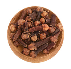 Dry spice cloves in wooden bowl isolated on white background with clipping path. Top view. Flat lay