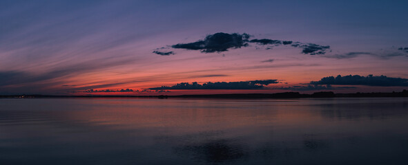 Fototapeta na wymiar Panorama of the colorful sunset over the Minsk sea, Belarus