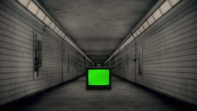 Green Screen TV Spooky Underground Subway Hallway Zoom In. Walking Through an eerie subway corridor with a green screen tv. Film damage effect