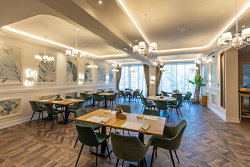 Interior of a modern empty restaurant with brown tiled floor