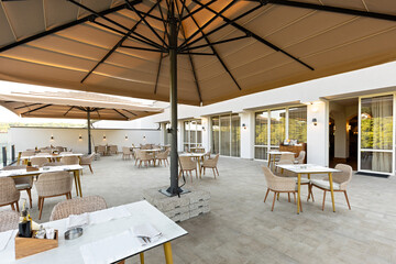 Empty terrace hotel restaurant with sun shades