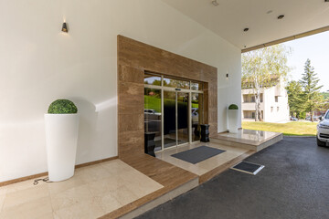 Hotel entrance sliding door with marble wall